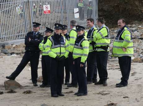 Garda� look on as protesters assert their rights to access the water.